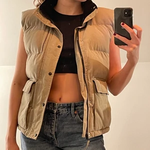 Beige väst  - Väldigt fin och cool väst. Storleken är i barnstorlek men passar mig som ofta är en M och är 173 cm, och skulle även passa s & xs beroende på passform. Väldigt fint skick 