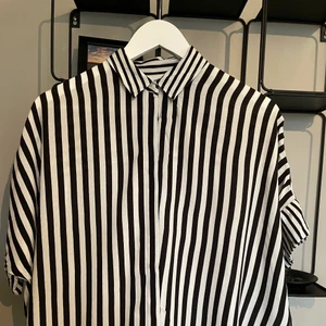 Randig trekvartärmad skjorta - Denna lite pösiga skjorta från Monki i ett superskönt material. 