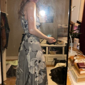 grå 90s långklänning - Jättefin långklänning i grått och blommigt från 90-talet! Går att dressa upp med klack och pärlor eller ha till vardags som en fin sommarklänning! Knyts med svart sammetsband i ryggen så flexibel i storlek och passform! Skickas mot fraktkostnad eller så möts vi upp i Malmö eller Lund! 🖤💗🤍