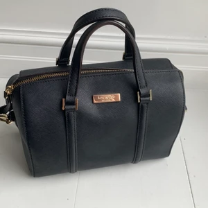 Kate spade satchel bag - Denna supersöta klassiska väska från Kate Spade är i ett bra skick med små tecken på användning, då det varit en favorit hos mig i flera år. Trots sin relativt lilla storlek får man plats med förvånansvärt mycket innehåll och funkar perfekt både till vardag men även till festligare tillställningar. Köpt i USA 2015 för cirka 1700kr. Köparen står för frakten💗 OBS! Pris kan diskuteras