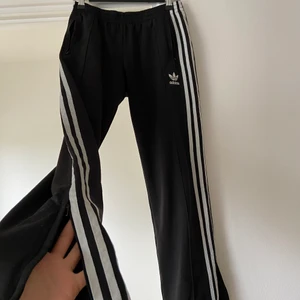 Adidas byxor med dragkedja st 38 - Topp skick, knappt använda. Har fickor med dragkedjor och även dragkedja längst ner vid ankeln. Kan fraktas med postnord skicka lätt 