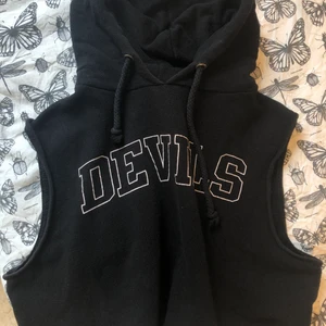 Croppad Hoodie stl L - Croppad hoodie utan ärmar i collegetyg, fint skick! Funkar på mig som använder M vanligtvis. Säljer av mycket kläder nu pga flytt, så passa på medan chansen finns! 🌸
