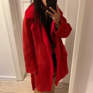 Red shearling coat with reversible belt. Pockets. Super warm, comfy and chic. 