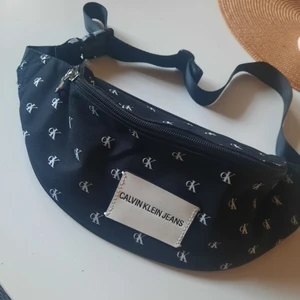 Oanvänd calvin Klein midjeväska - Vet ej om den är äkta eller ej. Jäkligt snygg men har inte hunnit bli använd. Två fack.Djur och rökfritt hem. Fraktar eller möts upp!