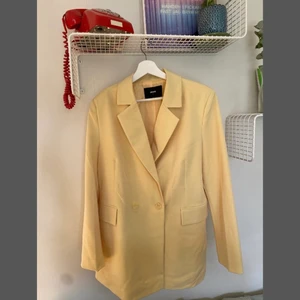 Kavaj i pastellgul - En pastellgul kavaj i storlek L, använd fåtal gånger vilket gör att den är i ett fint skick.