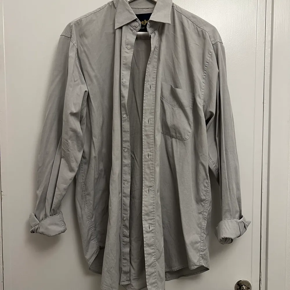 Ljusgråskjorta i 100% bomull, ingen märkning men sitter som en L-XL. Skjortor.