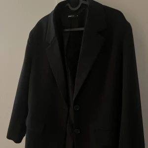Svart kavaj från Gina Tricot - Svart kavaj från Gina i avslappnad modell säljes pga dubbletter. Fint skick , använd fåtal gånger 