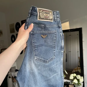 Vintage Armani jeans - Säljer dessa vintage Armani jeans! Midrise och avsmalnande ben. På lappen står det strl 29, men jag skulle säga 26, kolla gärna måtten nedan 🫶🏻  Midjemått: ca 66 cm Innerbenslängd: ca 72 cm Livhöjd: 27 cm  Finns tyvärr ett litet hål på vänster bakficka. 