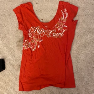 drain tröja  - rosa/röd rip curl t-shirt med v-ringning. väldigt snygg men kommer ej till användning 