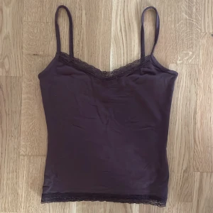 Linne med spets - Brunt linne med spets i halsringen och nedtill, perfekt längd till ett par low-waist byxor🥰