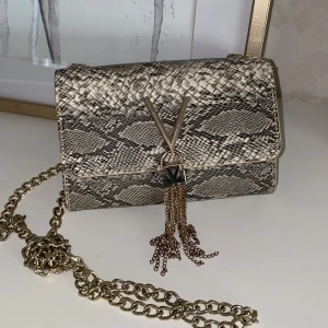 Mini Valentin väska - Mönstrad Valentino väska i ”orm”skinn. Lite skråmor på märket annars fint skick 