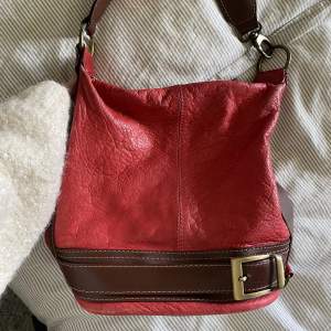 En så fin röd väska med vintage känsla som passar perfekt nu till höst/vinter 