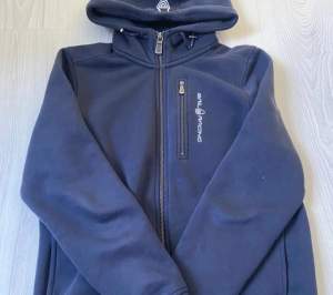 Mörkblå zip up hoodie från sail racing. Skick 8/10 nypris: 1000.