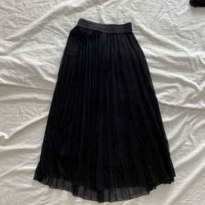 Svart plisserad midikjol Bershka - Resår i midjan, faller jättefint! 