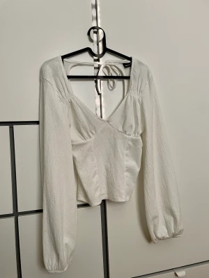 Vit linne blus med öppen rygg  - En jätte fin vit linne blus med öppen rygg, nyköpt och oanvänd, jätte fin för sommaren, storlek XS