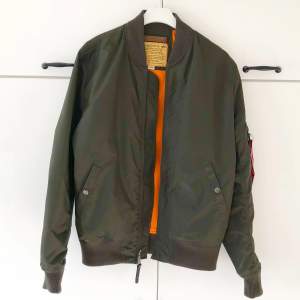 Alpha Industries Bomberjacka för vår och sommaren. *Storlek : (L) Likt många Alpha Industries Bomberjackor är denna liten i storleken, den passar bäst dig med storlek M eller M/L.  * Färg : Olivgrön  * Skick : Ny utan prislapp  Skick : 10 av 10 