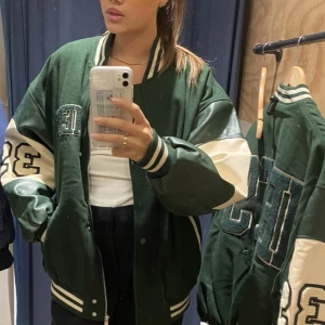 College Jacka Urban Outfitters  - Grön college jacka från Urban outfitters. Som ny, knappt använd. Inte tillgänglig längre hos Urban. Nypris: 1500. (Frakten står köparen för🫶🏼)