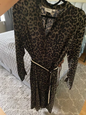 Klänning Saint tropez - Långärmad klänning från Saint Tropez. Används med eller utan tillhörande skärp. 