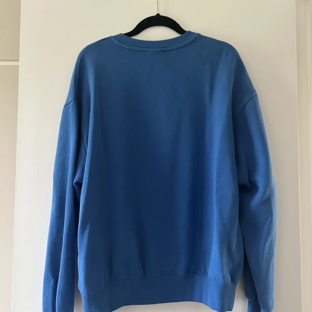 Blå swetshirt med stort tryck framtill. Från pull&bear storlek S. Tröjan är lite boxig modell. Använd få gånger och är i bra skick. . Tröjor & Koftor.