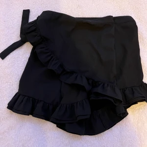 Svart kjol - Svart kjol med inbyggda shorts i nyskick, dvs aldrig använd. Passar stl xs-m.