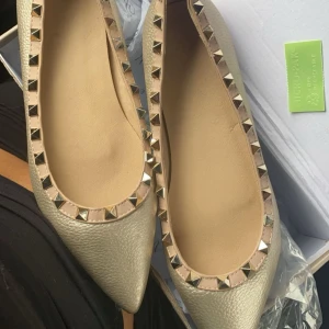 Ballerinaskor med nitar - Säljer dessa fina spetsiga ballerinaskor i en guldaktig färg med guld nitar! Köpte de nya på second hand och de var tyvärr för små för mig så de är helt oanvända! Skriv gärna för fler bilder eller frågor 💞