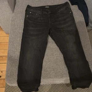 Svarta jeans från Jack and Jones  - Snygga svarta jeans från Jack and Jones. Perfekta för en avslappnad stil. Den har hål som man ser igenom på bild 3-4 på båda låren. Storlek är 30 & 30.