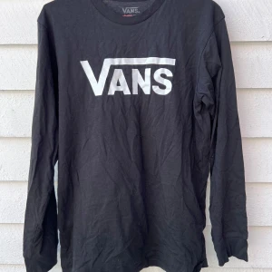Svart långärmad tröja från Vans - Säljer en svart långärmad tröja från Vans med deras ikoniska logga i vitt på bröstet. Perfekt för en casual look och passar till allt. Tröjan är i bra skick och superbekväm att ha på sig. Perfekt för höst och vår! Aldrig använd 
