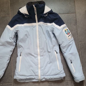 J. Lindeberg Jacka - En figursydd jacka från J. Lindeberg. I storlek xs. Säljer då den tyvärr blivit för liten. I perfekt skick, har varit så nöjd med denna jacka. Jag har använt den som skidjacka. Goretex och dun.