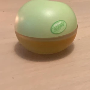 Parfym DKNY Delicious Delights Cool Swirl 50 ml(ca 35-40 ml kvar) - Fräsch och fruktig parfym från DKNY i en rund flaska med grön och gul design. Doften har söta och kokosnötsaktiga toner med inslag av frukt, nötter och vanilj. Mellannoter av sorbet och pistage samt basnoter av heliotrop och patchouli.