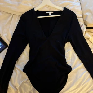 Långärmad body med v-ringning - skitsnygg men använder aldrig, endast använd en gång. Köparen står för frakten❤️‍🔥