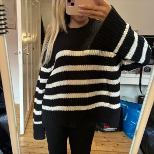 Stickad tröja  - Randig stickad tröja från Gina Tricot. Slitsar på armarna. Storlek S.