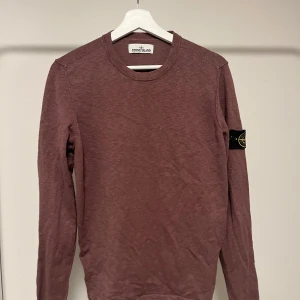 Vinröd långärmad Stone Island tröja  - Säljer en stilren vinröd långärmad tröja från Stone Island. Tröjan har en klassisk rund halsringning och det ikoniska märket på ärmen. Perfekt för en avslappnad och trendig look. Nypris 2500kr. Stl M, använd ett fåtal gånger. Tags och kvitto medföljer.