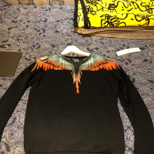 Svart  Marcelo Burlon sweatshirt  - Säljer min Marcelo Burlon sweatshirt som jag köpte i butik. Kvitto, tag och påse finns. Den är sparsamt använd och finns inga synliga skador. Storlek xs. Skick 9/10. Vid frågor bara skriv, går med på byten. Mitt pris 1699 nypris 5000kr 