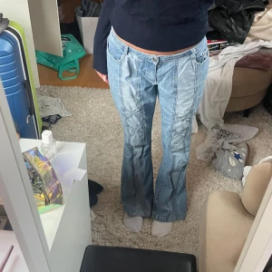 Blå bootcut jeans från Gojane - Snygga blå bootcut jeans från Farmoso med klassisk femficksdesign och låg midja. Perfekta för en avslappnad stil med en touch av retro. Passar bra till sneakers eller klackar. Jag är 175cm.