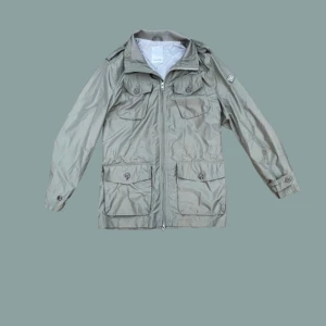 Olivgrön vindjacka från J.Lindeberg - Säljer en snygg olivgrön fieldjacka från J.Lindeberg i storlek M. Jackan har dragkedja och flera praktiska fickor med knappar. Perfekt för vår och höst med sin stilrena design och långa ärmar. Passar både till vardags och lite finare tillfällen. //Tranquilo Moda