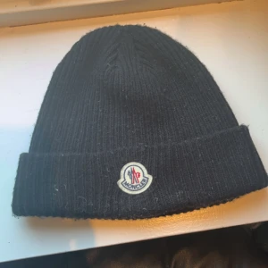 Moncler mössa - En jättesnygg Moncler mössa perfekt inför vintern. Mössan är svart och inga konstigheter. Mössan sitter som en vanlig mössa Pris kan diskuteras vid snabb affär 