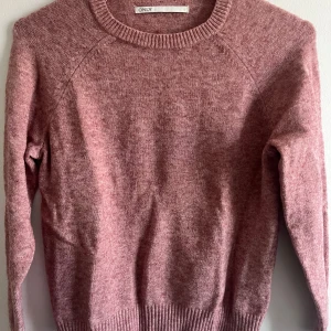 Rosa stickad tröja från ONLY - Säljer den här helt nya rosa stickade tröja från ONLY. Tröjan har långa ärmar och ribbade kanter vid hals, ärmslut och nederkant.💞💞💞