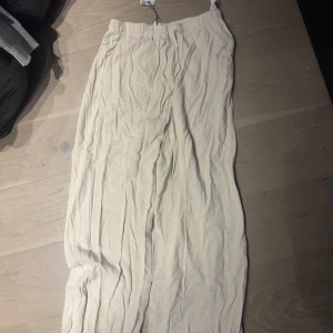 Beige linnebyxa  - Säljer en stilren beige linnebyxa från stradivarius. Linnebyxorna har en elastisk midja för en bekväm passform och är tillverkad i ett lätt och luftigt material, perfekt för varmare dagar.