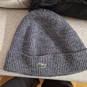 Used and a slight imperfection at the middle bottom on the beanie that you can see