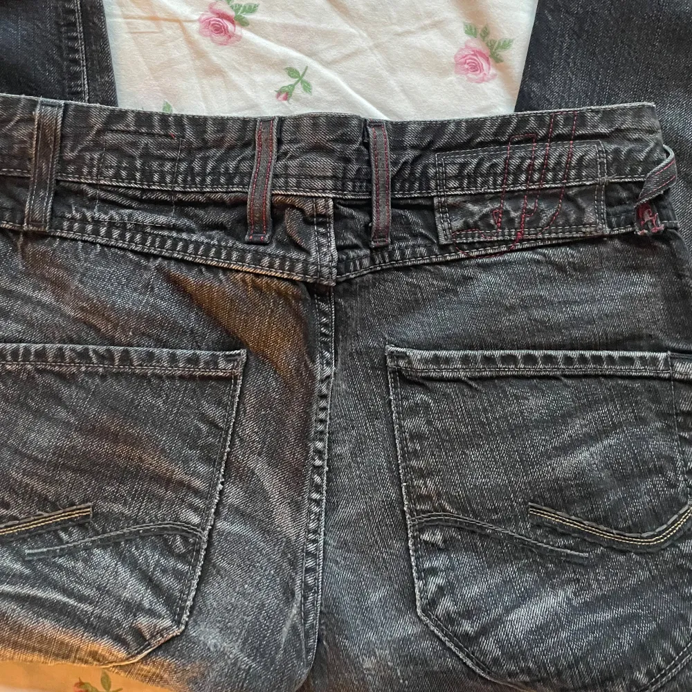 Utsvängda jeans från Jackandjones Fina röda detaljer  Midjemått:77 Innerbenslängd:81. Jeans & Byxor.