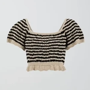 Randig stickad topp från Gina Tricot - Säljer en jättesöt randig stickad topp från Gina Tricot i svart och beige. Toppen är croppad med korta ärmar och har en söt volangdetalj vid nederkanten. Har aldrig kommit till användning för mig så den är i nyskick💞 