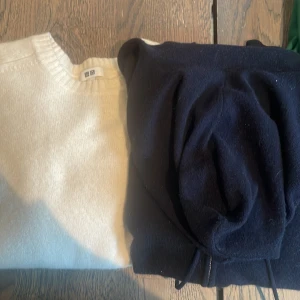 Vit och marinblå tröja från Uniqlo - Två stilrena tröjor från Uniqlo i storlek M. Den ena är vit och den andra är marinblå. Perfekta för både vardag och lite finare tillfällen. De är mjuka och bekväma, och passar bra till höst- och vintergarderoben.