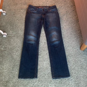 Lågmidjade jeans - Mörkblå utsvängda lågmidjade jeans             Midjemått: 41 cm   Innerbenslängd: 81 cm