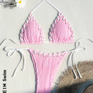 Rosa bikini - Snygg rosa bikini med ribbad textur och vita knytband. Toppen har trekantsform och underdelen är en klassisk trosa med knytning på sidorna. Perfekt för en dag på stranden eller vid poolen. Helt oanvänd i storlek XS🩷