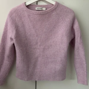 Ljuslila tröja  - Mysig ljuslila tröja  i en mjuk och fluffig kvalitet. Tröjan har en rund halsringning och långa ärmar, perfekt för kyligare dagar. Den har ribbade kanter vid ärmslut och nederkant för en snygg passform.