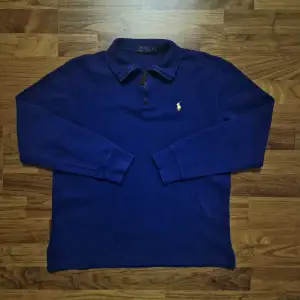 Säljer en snygg djupblå Quarter-Zip från Ralph Lauren i storlek S. Den har en dragkedja vid halsen och det klassiska Ralph Lauren-logotypen broderad i gult på bröstet. Perfekt för dig som vill ha 