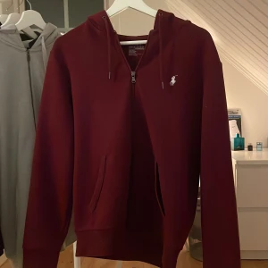 Vinröd hoodie från Polo Ralph Lauren - Tjenare, Säljer felfri full zip hoodie ifrån Ralph lauren. Storlek Medium/small funkar också. Priset är inte hugget i sten! Vid minsta fundering så kontakta!