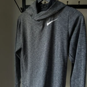 Träningstop - Säljer denna gråa träningstopp med luva från Nike, storlek 147-158cm, men kan jämföras med en xs, gott skick