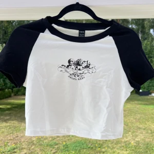Svart/vit crop top - En svart/vit crop top med tryck. Aldrig använd och det är därför den nu säljs! 🙌🏻💞 Storlek M men passar bra till mig som har S  (ALDRIG ANVÄND)  Längd: 43 cm Byst: 85 cm