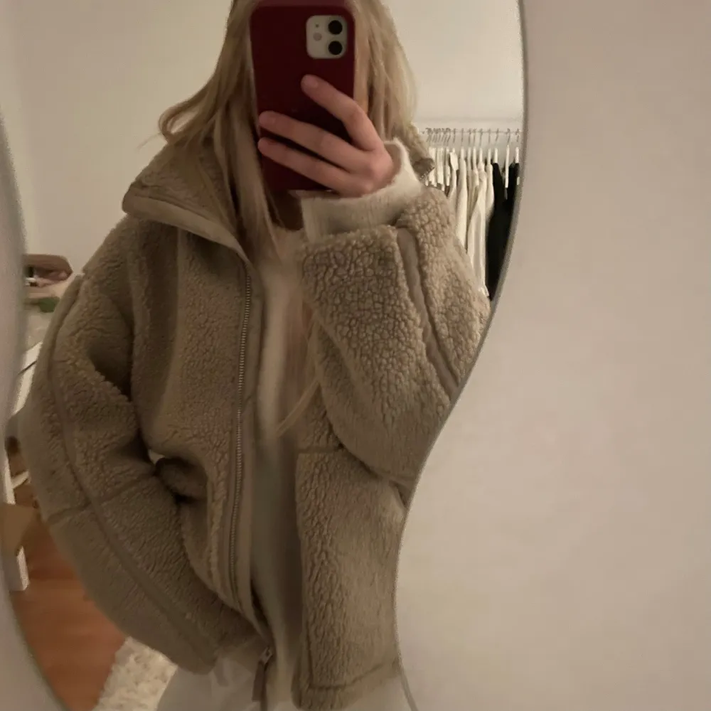 Populär beige teddyjacka i oversized passform från hm. Perfekt för höst och vinter med dragkedja framtill. Jackan är långärmad och gjord i ett mjukt teddy-material som håller dig varm och stilren. Ett måste för garderoben! . Jackor.